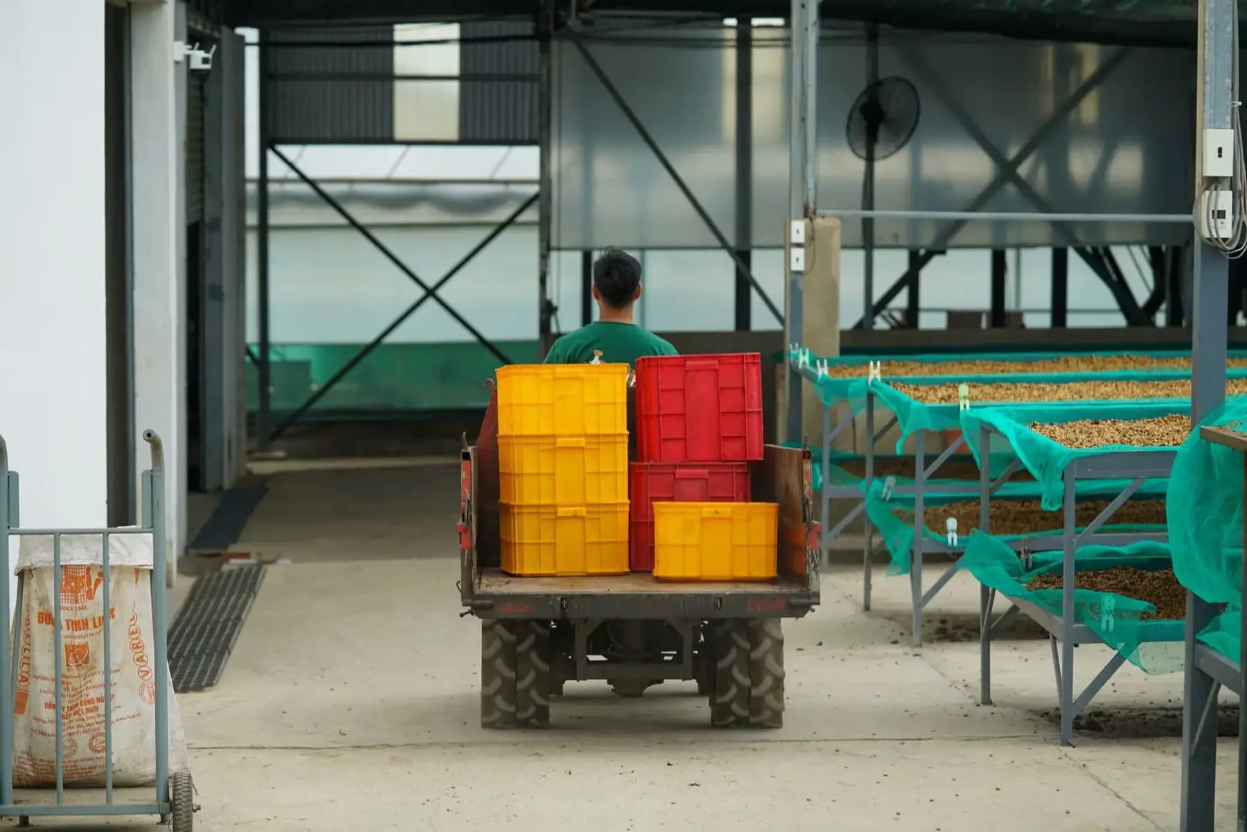 Coffee warehouse interior with stacked crates and processing equipment